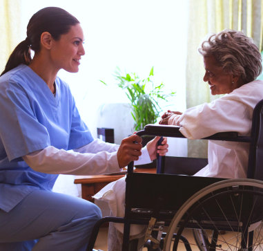 a caregiver woman and an elderly woman talking